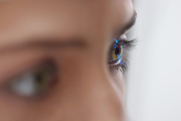 Woman Checking Eye Vision On Optometry Equipment.