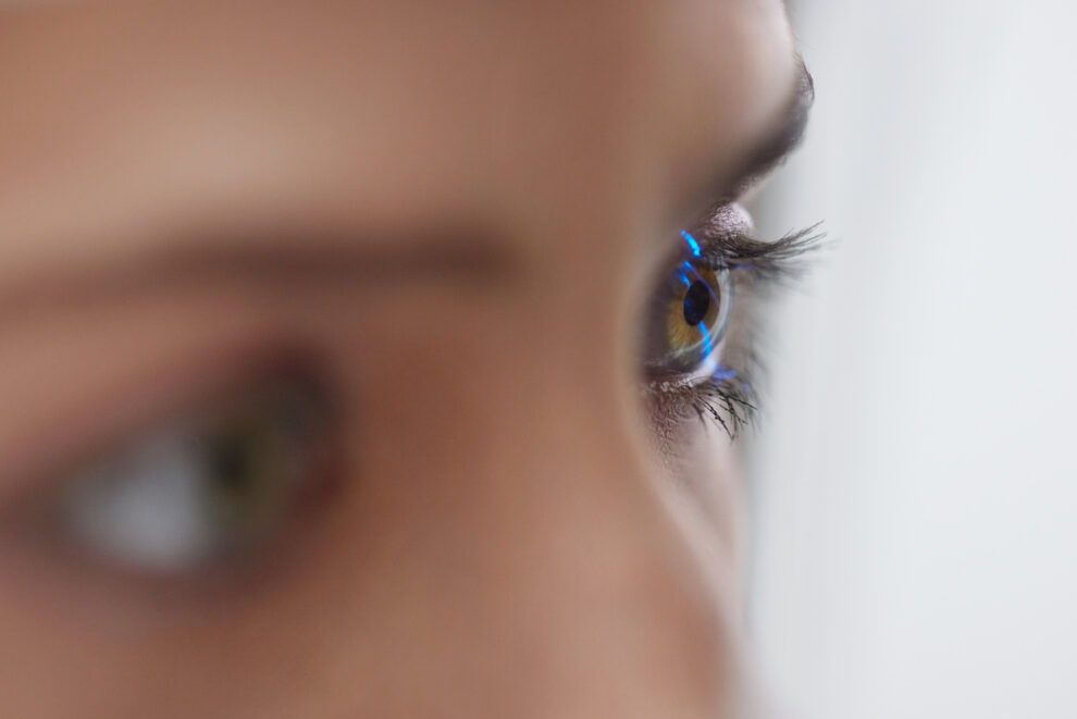 Woman Checking Eye Vision On Optometry Equipment.